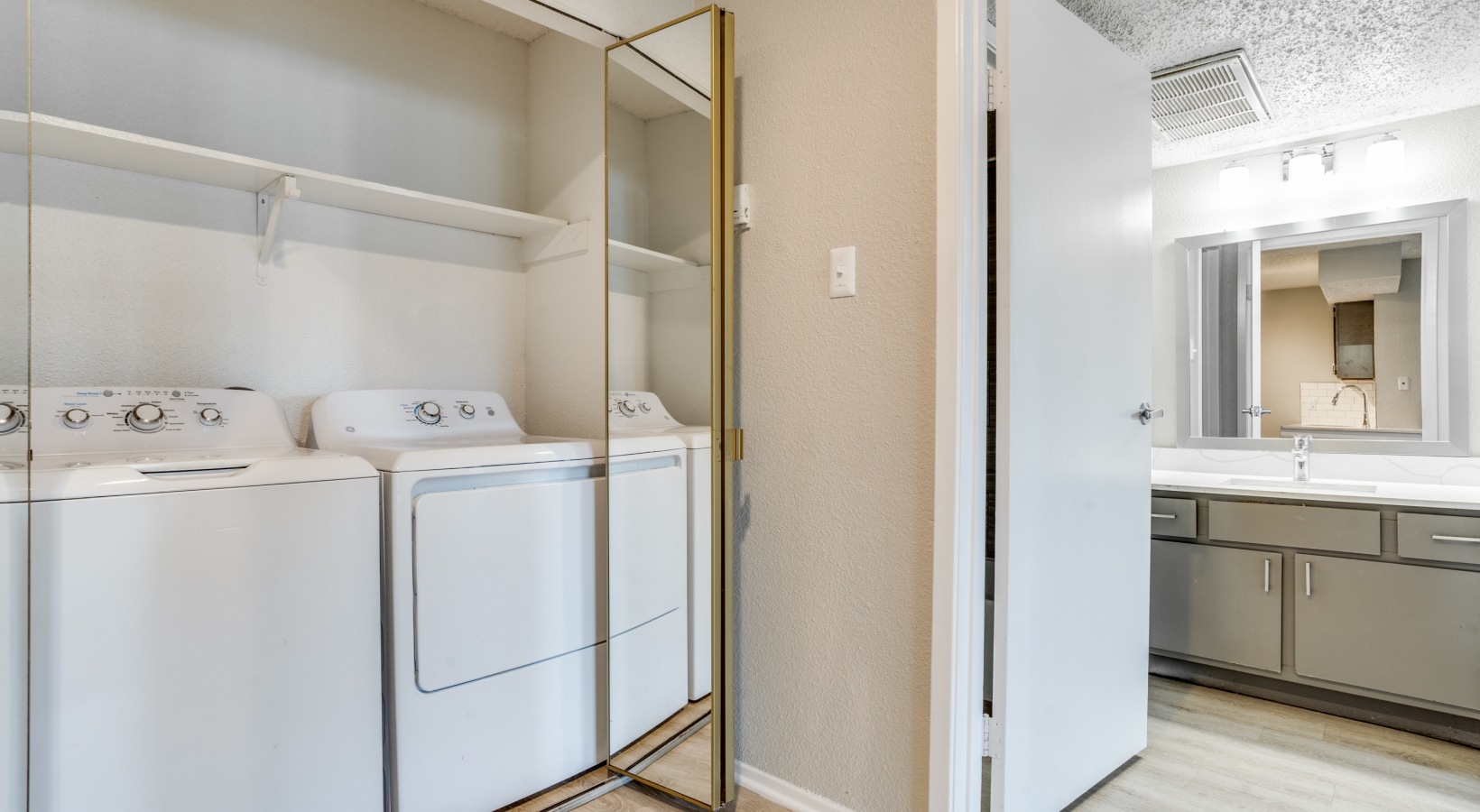 a laundry room with a washer and dryer in it at The Hudson