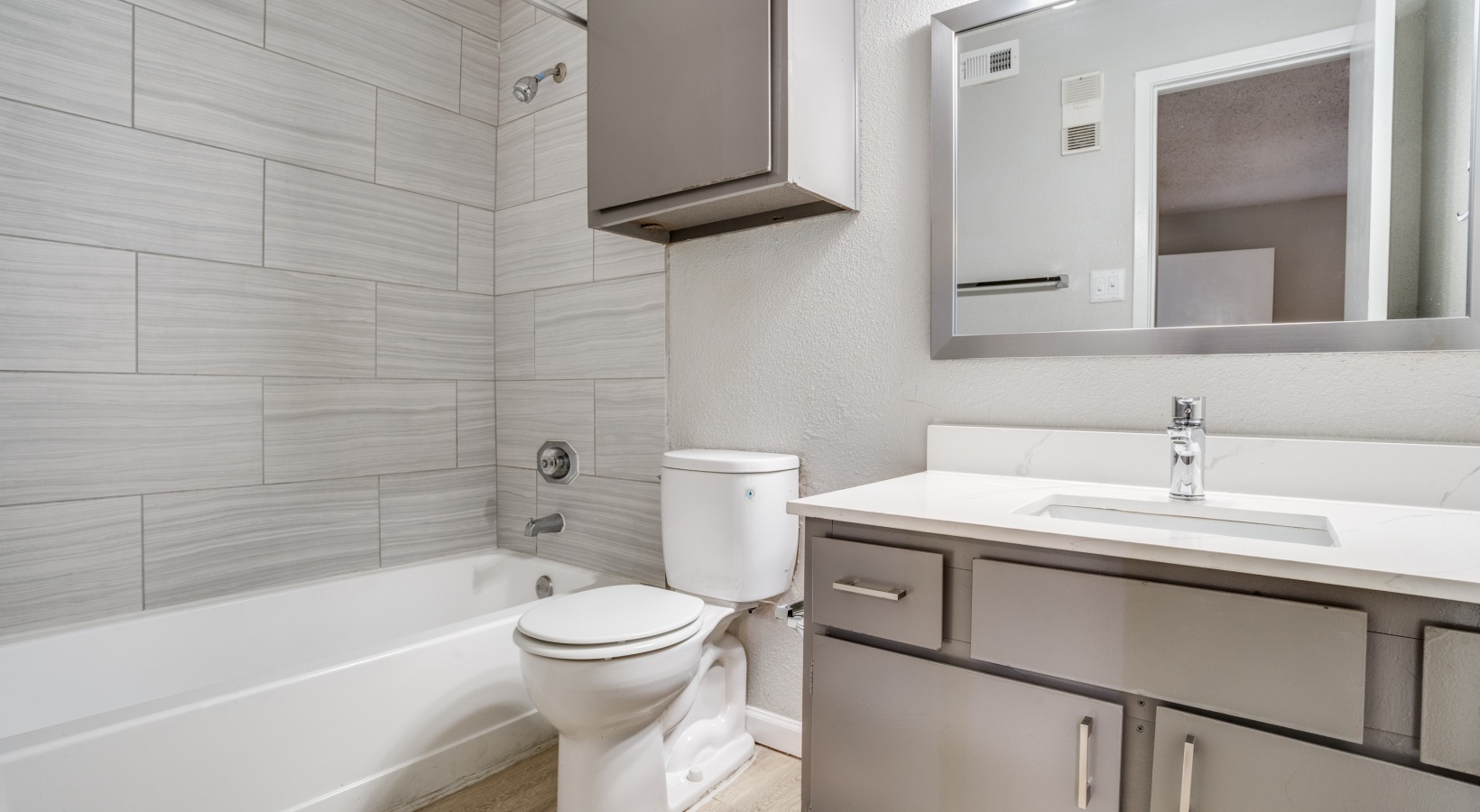 a bathroom with a toilet, sink and tub at The Hudson