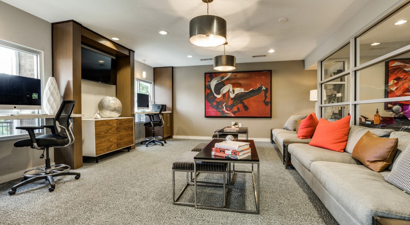 a clean and modern living room with couches and a television at The Hudson