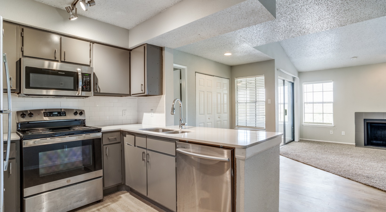 a kitchen with stainless steel appliances and a stove at The Hudson