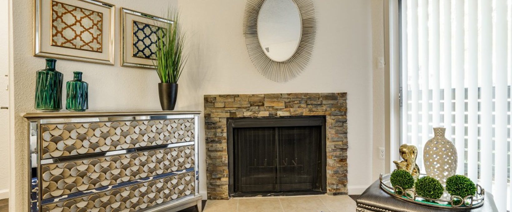 a living room with a fireplace and a mirror at The Hudson
