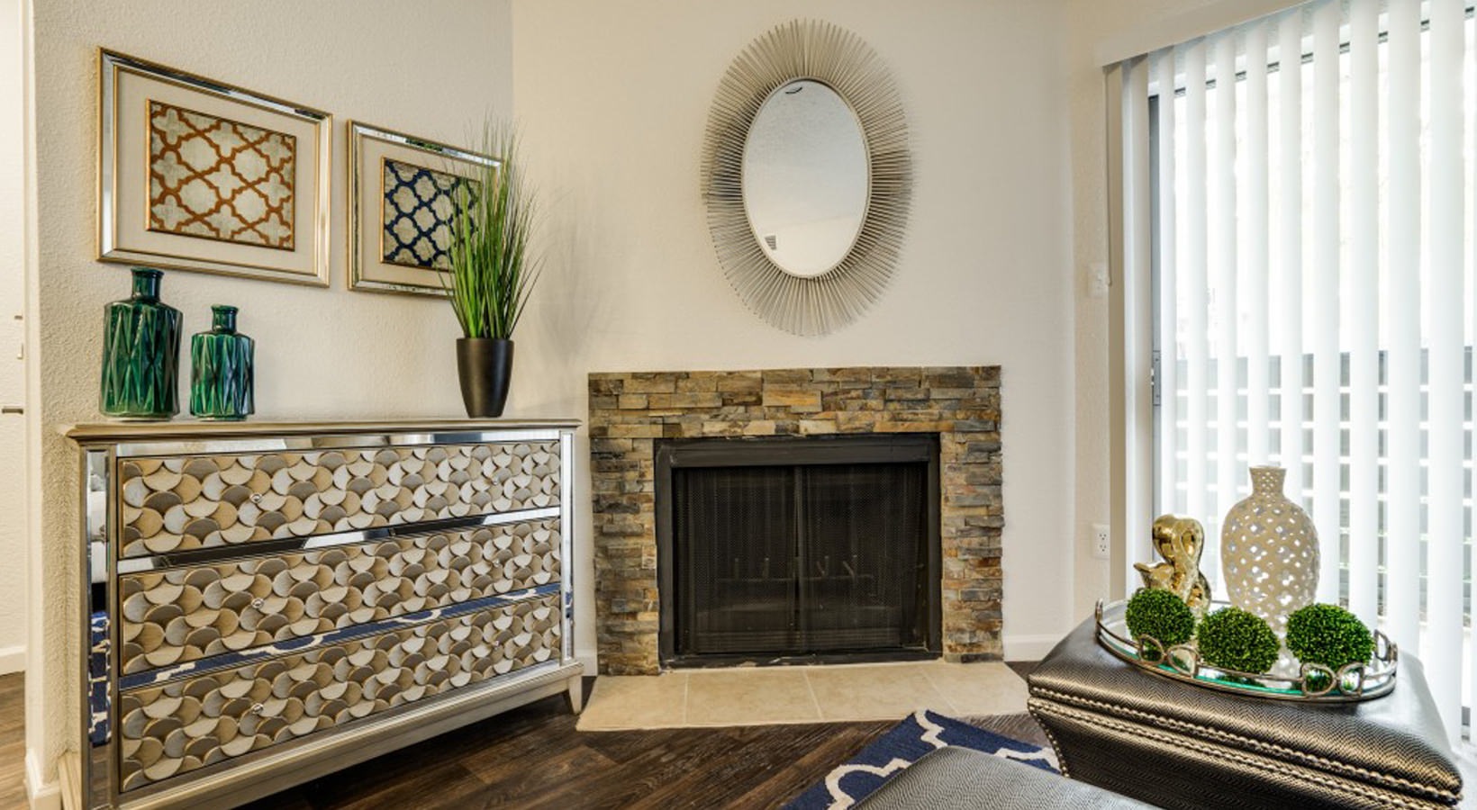 a living room with a fireplace and a mirror at The Hudson